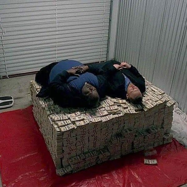 Негр лежит на деньгах