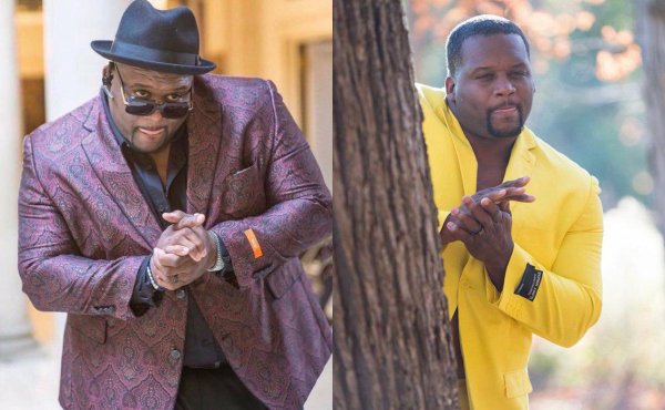 Негр в желтом костюме потирает руки