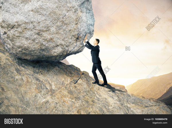 Человек катит камень в гору