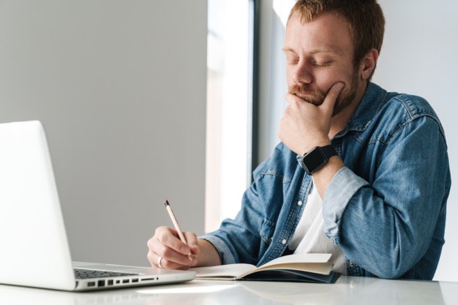 Мужчина записывает в блокнот