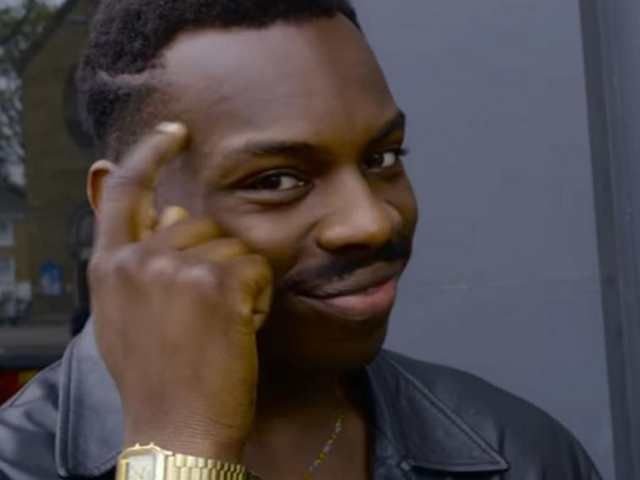 Мем негр с пальцем у Виска