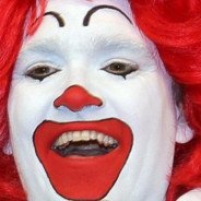 Человек красится в клоуна
