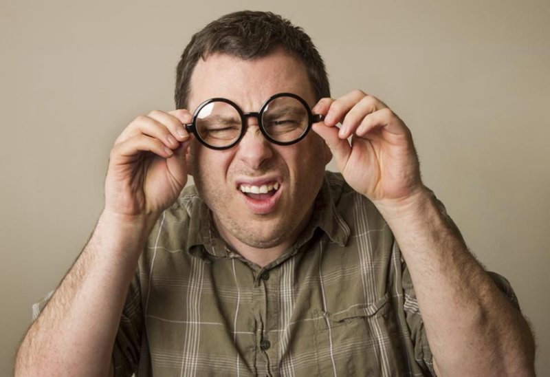 Человек в очках щурится
