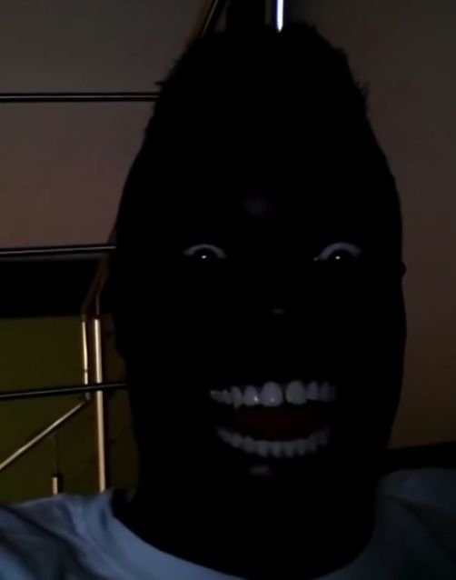 Негр улыбается в темноте