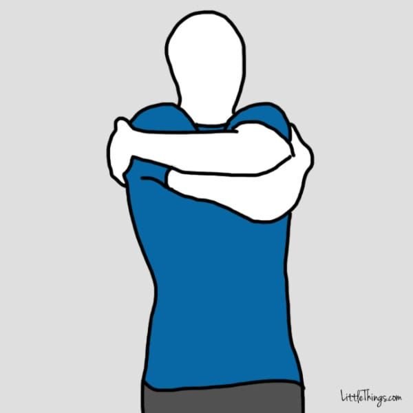 Обнимает себя за плечи