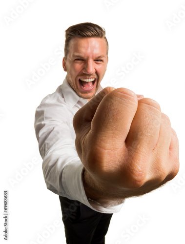 Грозит кулаком