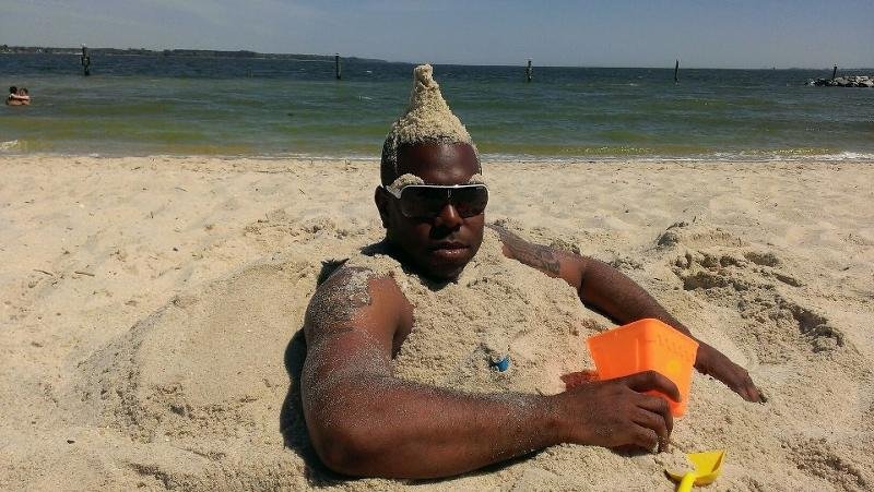 Негр лежит на песке