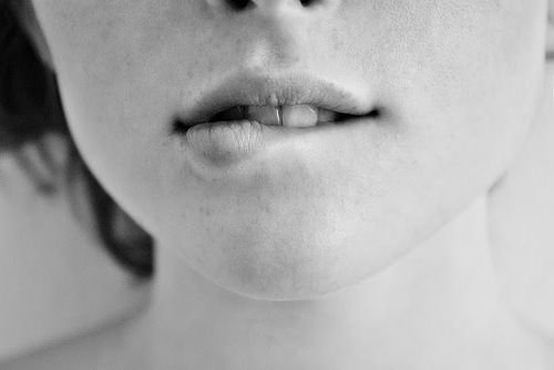 Девушка прикусывает нижнюю губу