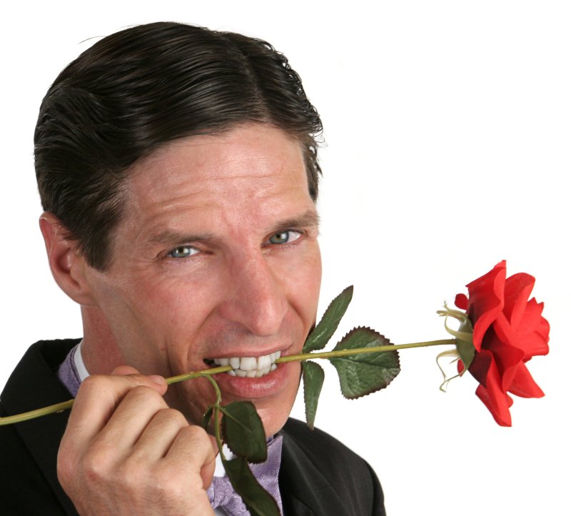 Мужчина с цветами в зубах