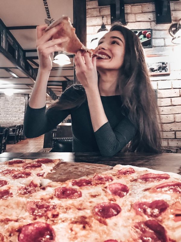 Девушка с пиццей в руках